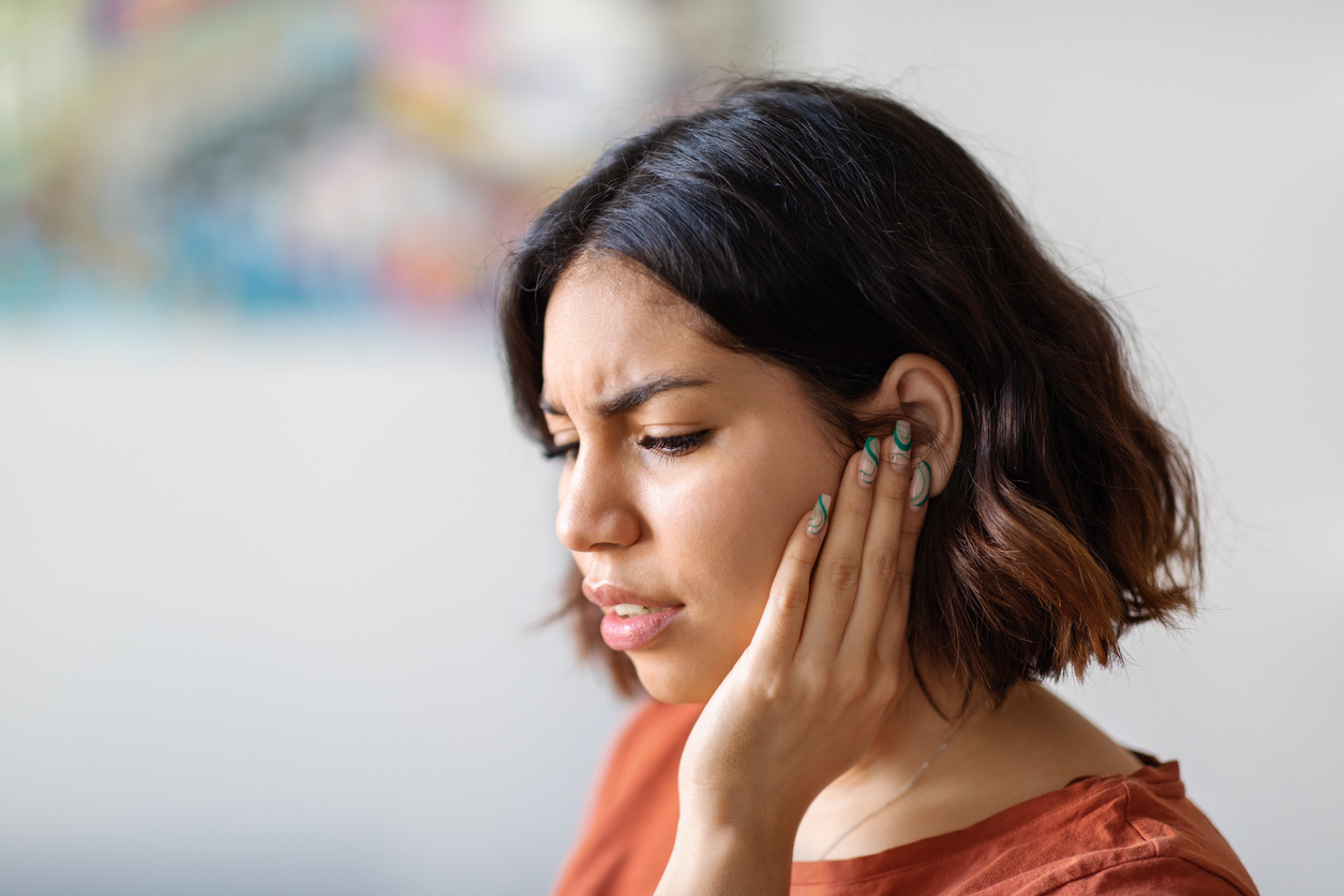 woman-with-ear-infection-holding-ear