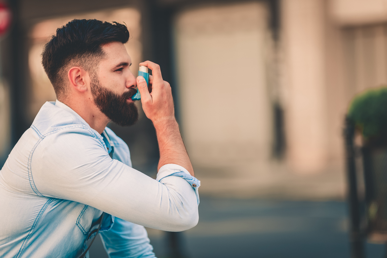 Man With Allergies Using Using Inhaler